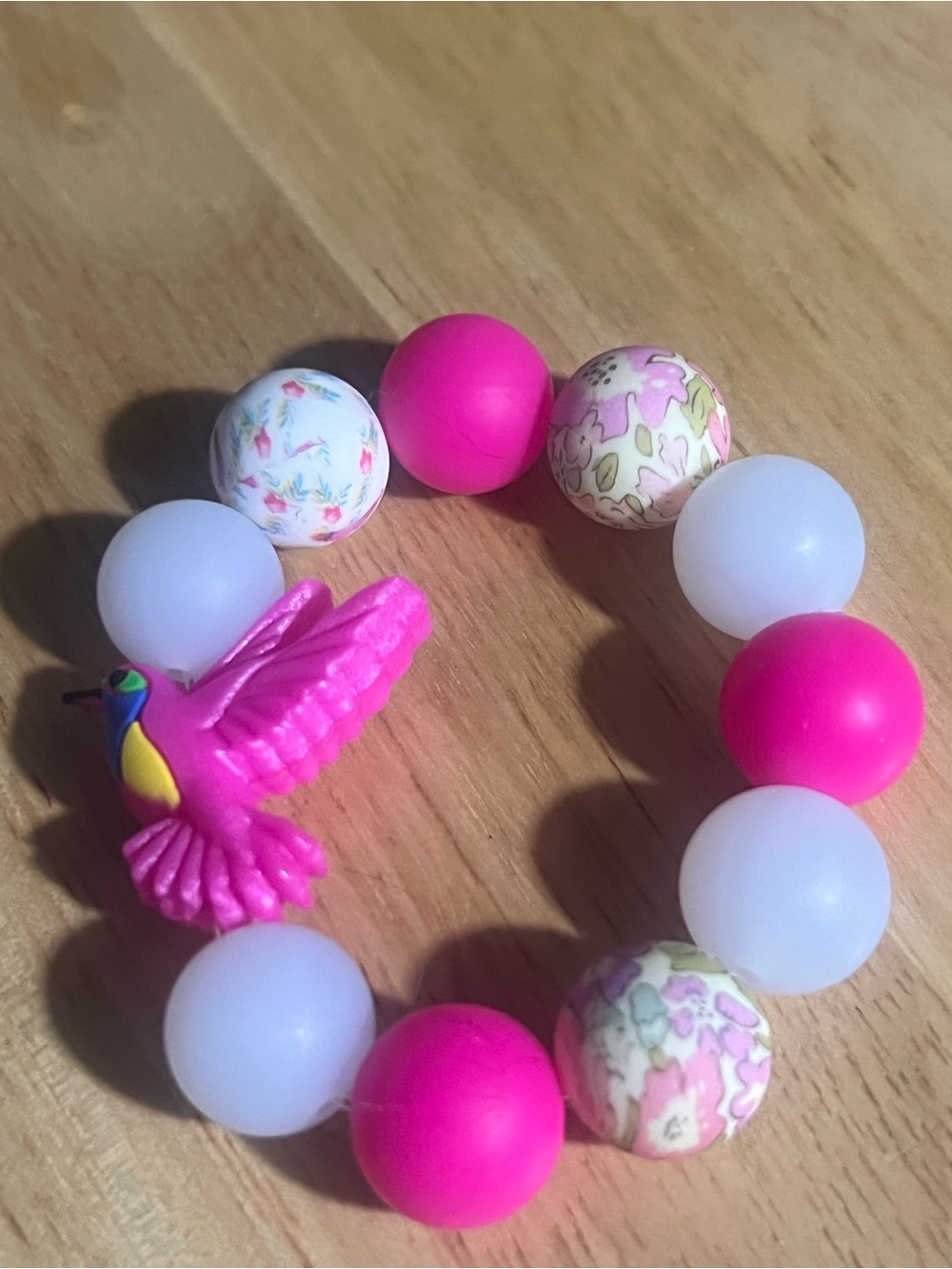 Pink Beaded Bracelet with Floral Accents and Hummingbird Charm B202